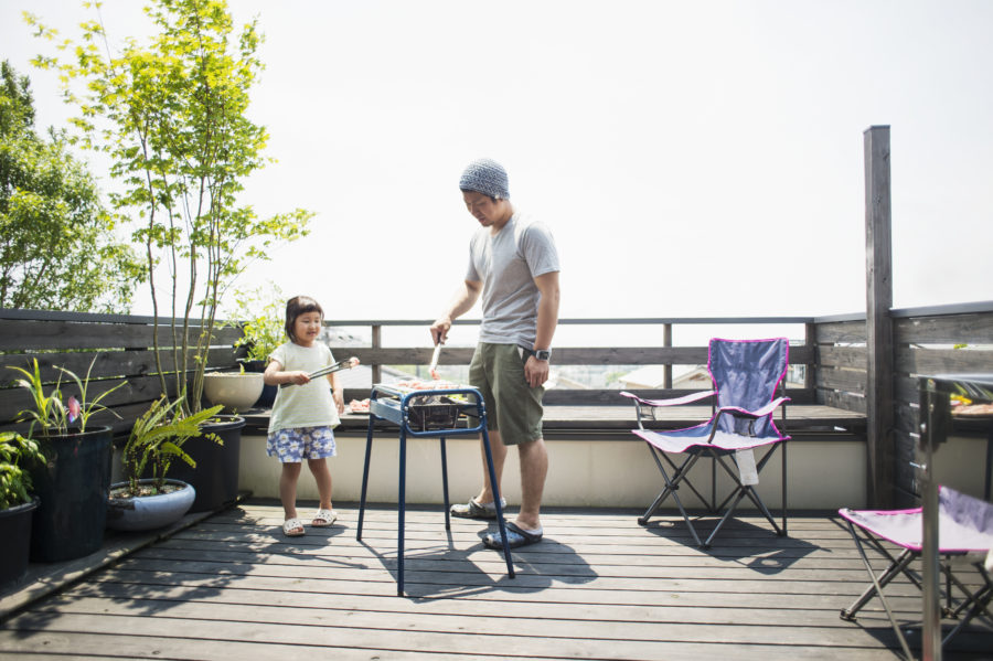 Father and daughter enjoying a barbecue on the terrace